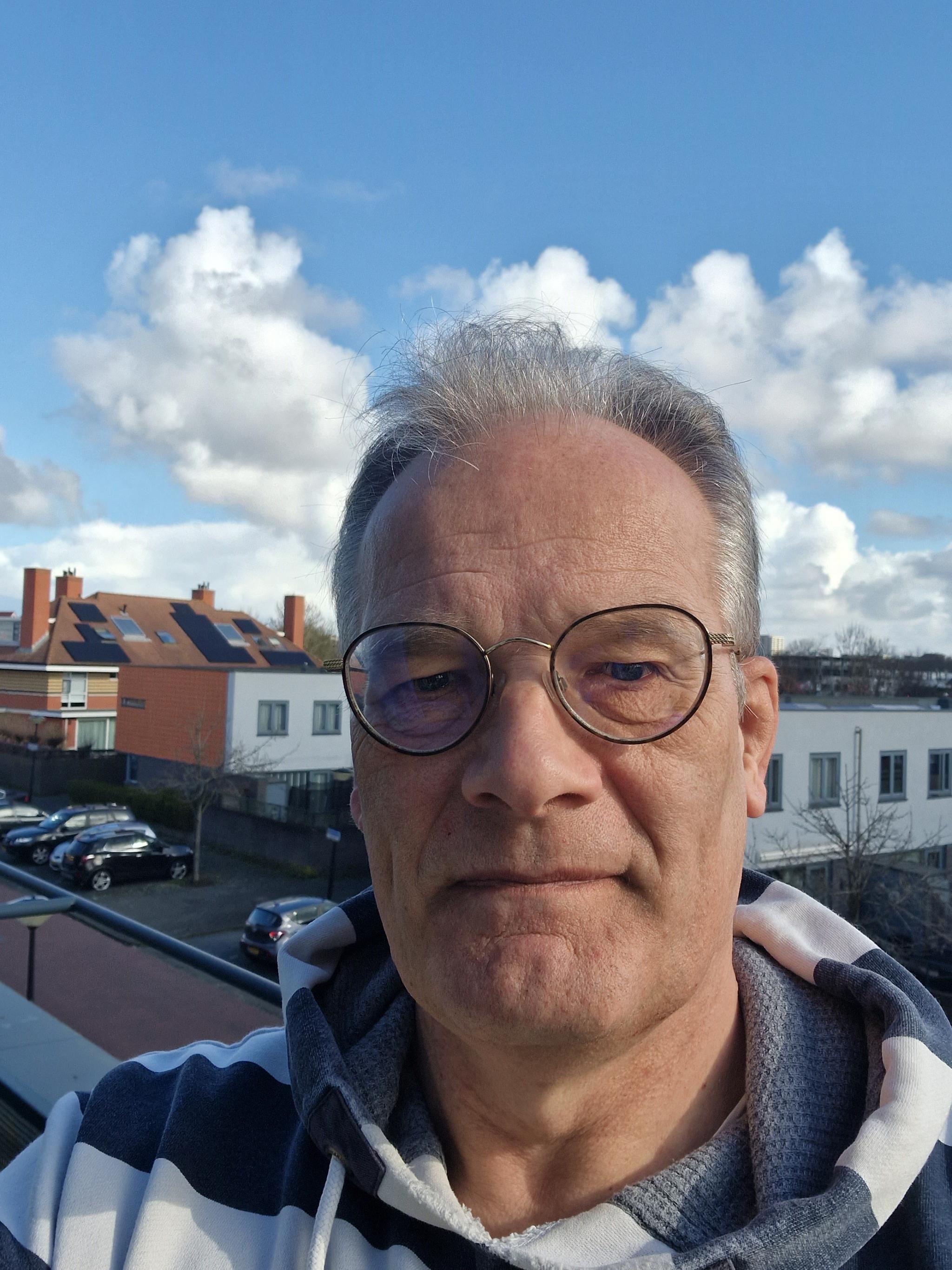 A picture of Jan Harm Brouwer - a man standing outside wearing a grey striped sweater