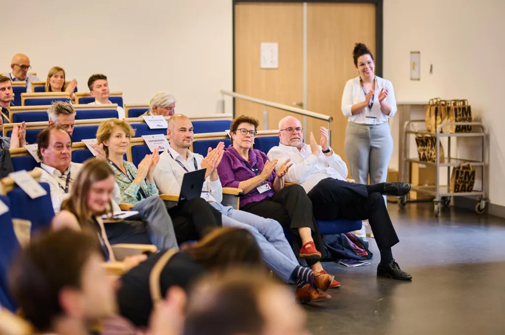 People clapping and smiling